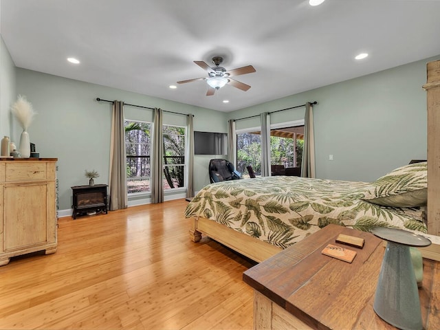 71-1371 Puu Kamanu Ln, Kailua-Kona, HI 96740 - bedroom featuring light wood-style flooring, recessed lighting, access to outside, a wood stove, and a ceiling fan