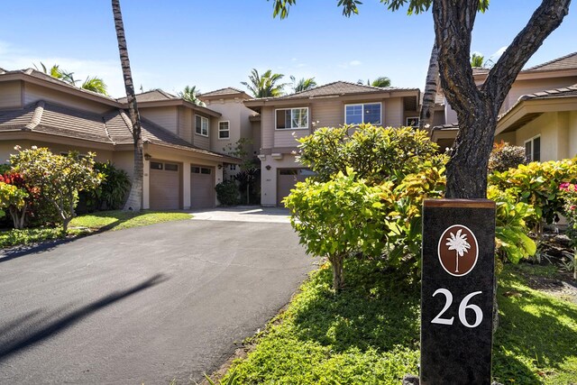69-555 Waikoloa Beach Dr Unit 2604, Waikoloa, HI 96738 - view of front of home featuring asphalt driveway, stucco siding, and an attached garage