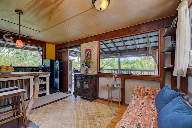12-7003 Kaihulali St, Pahoa, HI 96778 - kitchen with freestanding refrigerator, plenty of natural light, and wood finished floors