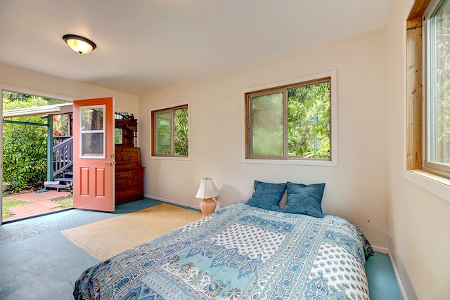 12-7003 Kaihulali St, Pahoa, HI 96778 - bedroom featuring multiple windows, baseboards, and access to exterior