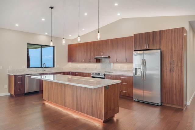 73-4493 Aloha Pl, Kailua-Kona, HI 96740 - kitchen with stainless steel appliances, under cabinet range hood, a center island, brown cabinetry, and dark wood-type flooring