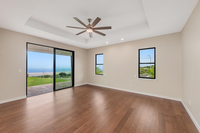 73-4493 Aloha Pl, Kailua-Kona, HI 96740 - unfurnished room with a tray ceiling, dark wood-type flooring, a ceiling fan, and recessed lighting