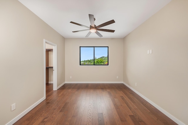 73-4493 Aloha Pl, Kailua-Kona, HI 96740 - unfurnished bedroom with a spacious closet, dark wood finished floors, a ceiling fan, and a closet