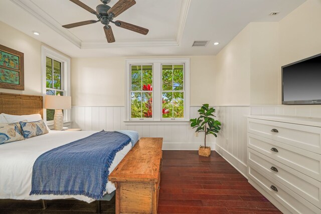 2640 Uluwehi St, Koloa, HI 96756 - bedroom featuring dark wood finished floors, a tray ceiling, multiple windows, wainscoting, and ceiling fan