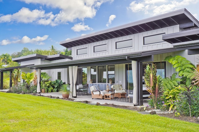 74-941 Kuni St, Kailua-Kona, HI 96740 - back of property with an outdoor living space, board and batten siding, a lawn, and a patio