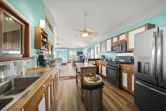88-1650 Papio Dr, Captain Cook, HI 96704 - kitchen featuring appliances with stainless steel finishes, dark wood-style flooring, ceiling fan, a sink, and vaulted ceiling