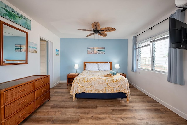 75-5766 Kuakini Hwy Unit 503, Kailua-Kona, HI 96740 - bedroom with wood finished floors, baseboards, and a ceiling fan
