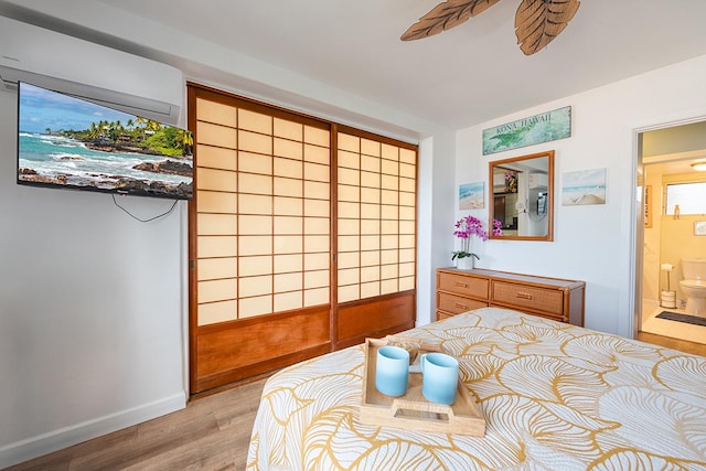 75-5766 Kuakini Hwy Unit 503, Kailua-Kona, HI 96740 - bedroom featuring light wood finished floors, ensuite bath, and baseboards