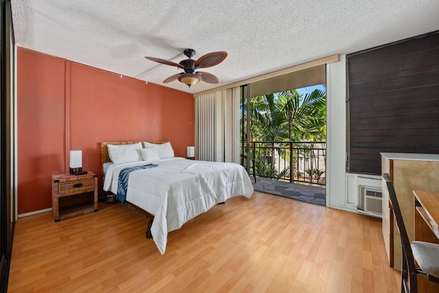 75-6026 Alii Dr Unit 5206, Kailua-Kona, HI 96740 - bedroom with a wall of windows, access to outside, light wood finished floors, a textured ceiling, and a ceiling fan