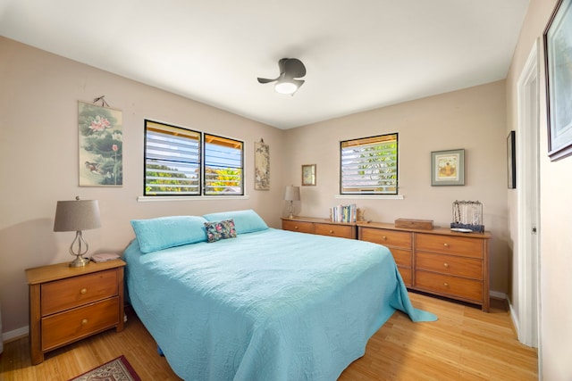 4911 Aliali Rd Unit 0002, Kapaa, HI 96746 - bedroom with multiple windows, light wood-style floors, and baseboards