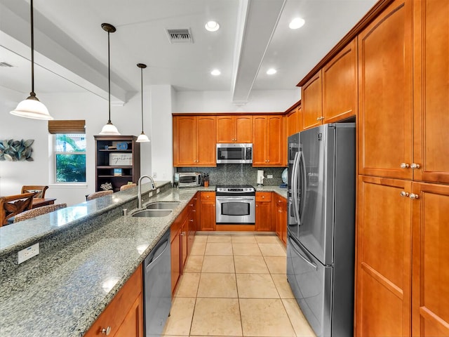 68-1125 Kaniku Dr Unit 2105, Kamuela, HI 96743 - kitchen featuring appliances with stainless steel finishes, a sink, tasteful backsplash, stone countertops, and brown cabinetry