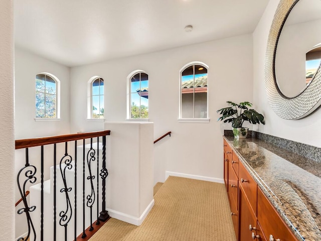68-1125 Kaniku Dr Unit 2105, Kamuela, HI 96743 - hallway featuring baseboards, an upstairs landing, and light colored carpet