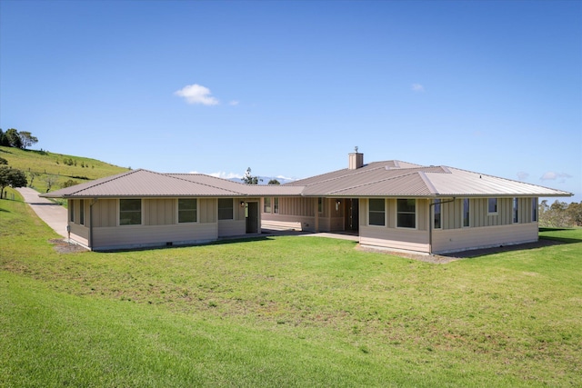 67-1027 Wainoenoe Rd, Kamuela, HI 96743 - rear view of house with metal roof, a chimney, and a yard