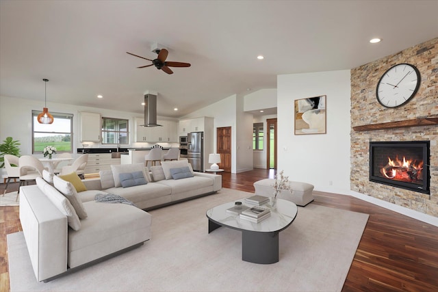 67-1027 Wainoenoe Rd, Kamuela, HI 96743 - living area featuring lofted ceiling, wood finished floors, ceiling fan, a stone fireplace, and baseboards