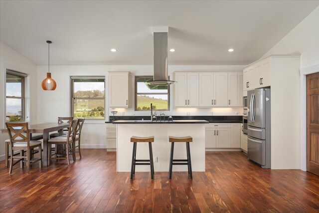 67-1027 Wainoenoe Rd, Kamuela, HI 96743 - kitchen with freestanding refrigerator, island range hood, dark countertops, dark wood-type flooring, and recessed lighting