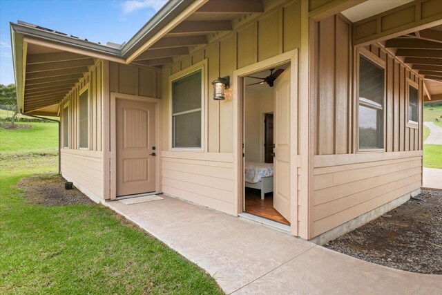 67-1027 Wainoenoe Rd, Kamuela, HI 96743 - property entrance with board and batten siding and a lawn