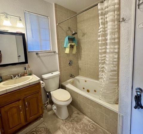 15-2690 Mahimahi St, Pahoa, HI 96778 - full bathroom featuring a combined bath / shower with jetted tub, tile patterned floors, toilet, and vanity