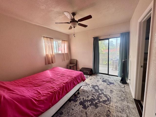 15-2690 Mahimahi St, Pahoa, HI 96778 - bedroom with access to outside, multiple windows, a textured ceiling, and ceiling fan