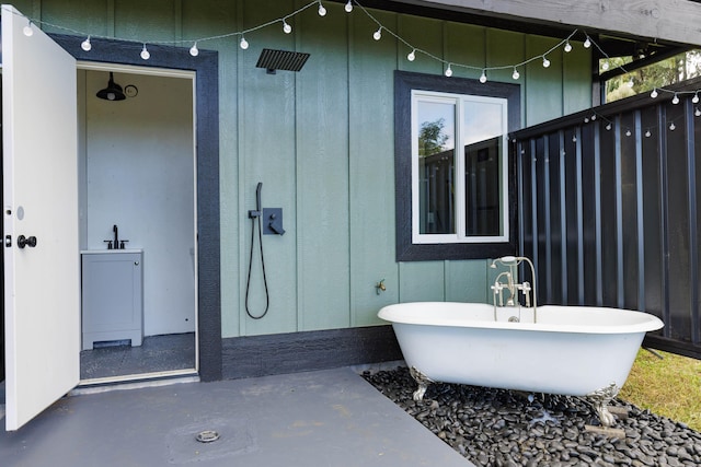 36-574 Spencer Rd, Laupahoehoe, HI 96764 - bathroom featuring a walk in shower, a freestanding bath, and concrete floors