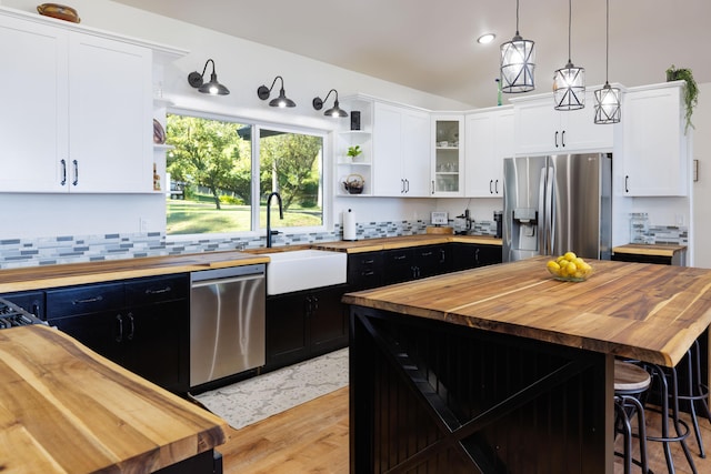 36-574 Spencer Rd, Laupahoehoe, HI 96764 - kitchen with butcher block counters, appliances with stainless steel finishes, open shelves, dark cabinetry, and lofted ceiling