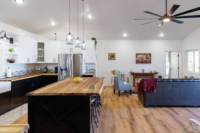 36-574 Spencer Rd, Laupahoehoe, HI 96764 - kitchen with stainless steel refrigerator with ice dispenser, wood counters, lofted ceiling, white cabinetry, and ceiling fan