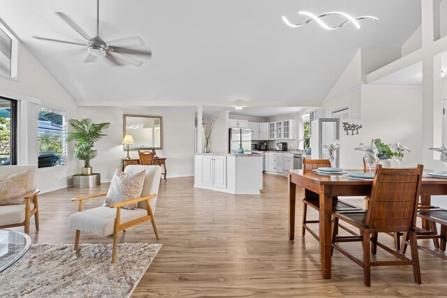76-6302 Leone St, Kailua-Kona, HI 96740 - dining area with healthy amount of natural light, high vaulted ceiling, a ceiling fan, and light wood-style flooring