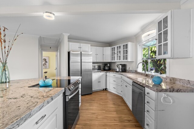 76-6302 Leone St, Kailua-Kona, HI 96740 - kitchen with stainless steel appliances, a sink, white cabinetry, light wood-style flooring, and crown molding
