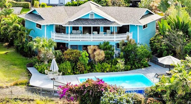 76-6302 Leone St, Kailua-Kona, HI 96740 - back of house with a shingled roof and an outdoor pool