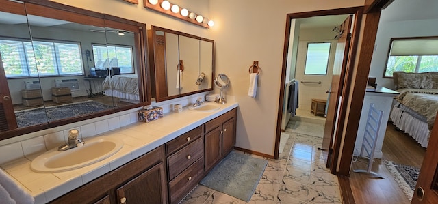 5359 Pau A Laka St, Koloa, HI 96756 - ensuite bathroom with marble look tiles, double vanity, plenty of natural light, and baseboards