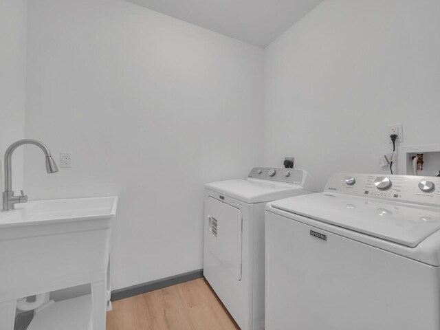 94-1679 Kaulua St, Naalehu, HI 96772 - laundry area with separate washer and dryer and light wood-type flooring