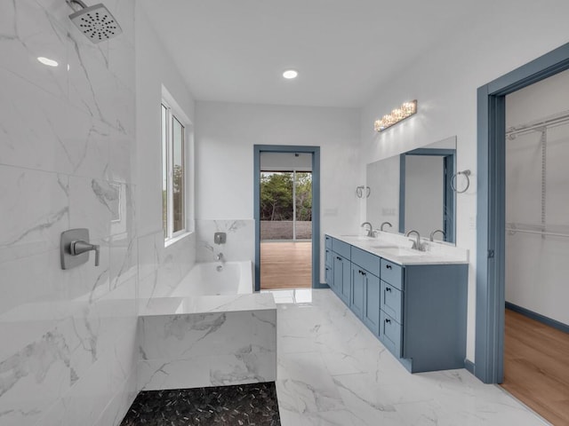 94-1679 Kaulua St, Naalehu, HI 96772 - bathroom featuring a garden tub, double vanity, a spacious closet, and marble finish flooring