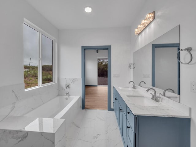 94-1679 Kaulua St, Naalehu, HI 96772 - bathroom with plenty of natural light, double vanity, marble finish flooring, and a bath