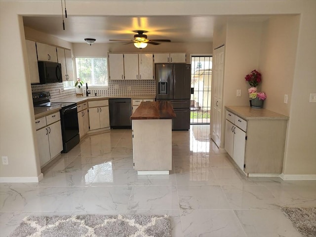 18-7862 N Lauko Rd, Mountain View, HI 96771 - kitchen featuring black appliances, tasteful backsplash, butcher block counters, and light marble finish flooring