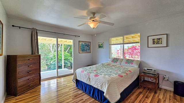 94-6663 Kamaoa Rd, Naalehu, HI 96772 - bedroom with multiple windows, access to outside, wood finished floors, and a ceiling fan