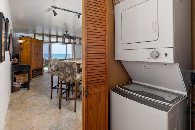 75-5888 Alii Dr Unit A4, Kailua-Kona, HI 96740 - washroom with stacked washer and clothes dryer, a ceiling fan, a water view, and track lighting