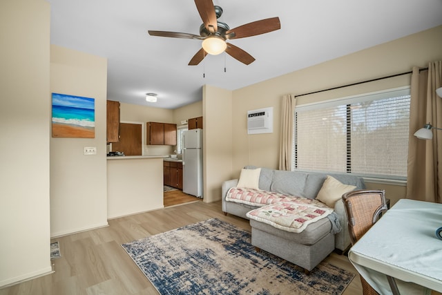 4720 Menehune Rd, Waimea, HI 96796 - living area featuring a ceiling fan, light wood finished floors, and a wall mounted air conditioner