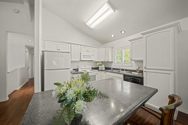 15-1663 Beach Rd, Keaau, HI 96749 - kitchen with white appliances, dark countertops, lofted ceiling, white cabinetry, and dark wood-style flooring