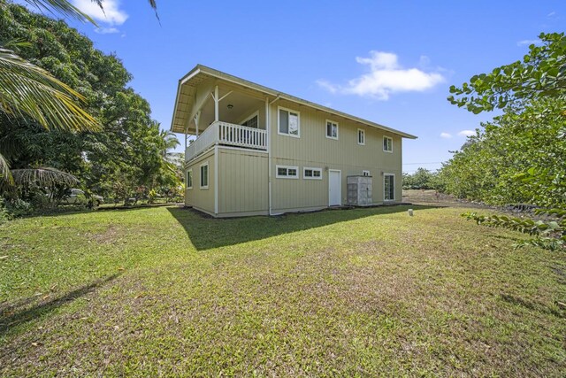 15-1663 Beach Rd, Keaau, HI 96749 - back of property with a lawn and a balcony