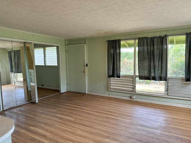 4854 Aliali Rd, Kapaa, HI 96746 - unfurnished living room featuring wood finished floors and a textured ceiling
