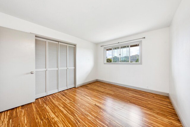 2969 Aloalo Pl, Lihue, HI 96766 - unfurnished bedroom featuring a closet, wood finished floors, and baseboards