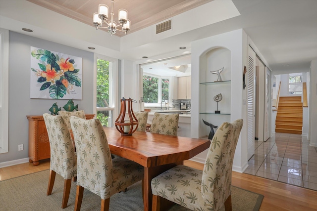 68-1375 Pauoa Rd Unit M4, Kamuela, HI 96743 - dining area with a chandelier, healthy amount of natural light, light wood-style flooring, stairway, and crown molding