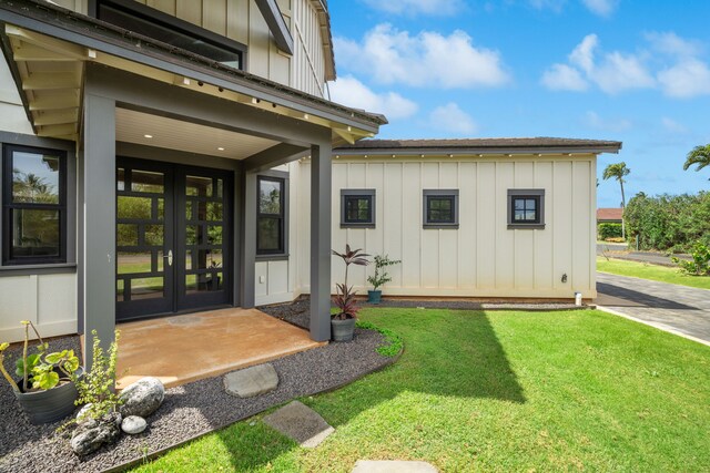 1647 Kelaukia St, Koloa, HI 96756 - entrance to property with board and batten siding, french doors, and a yard