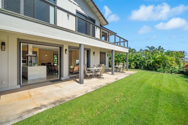 1647 Kelaukia St, Koloa, HI 96756 - back of property featuring a balcony, a lawn, a patio, and board and batten siding