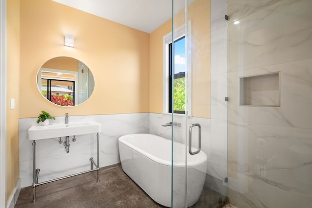 1647 Kelaukia St, Koloa, HI 96756 - full bathroom with tile walls, a soaking tub, wainscoting, and a shower with door