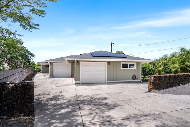 75-5726 Lamaokeola St, Kailua-Kona, HI 96740 - garage featuring concrete driveway and roof mounted solar panels