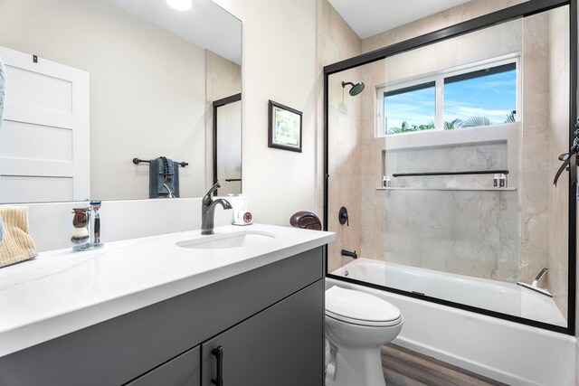 75-5726 Lamaokeola St, Kailua-Kona, HI 96740 - bathroom with vanity, toilet, enclosed tub / shower combo, and wood finished floors