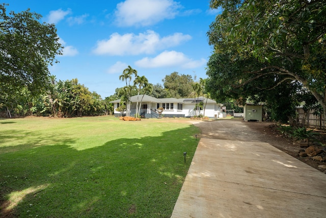 3018 Poipu Rd, Koloa, HI 96756 - single story home with concrete driveway, a storage unit, and covered porch