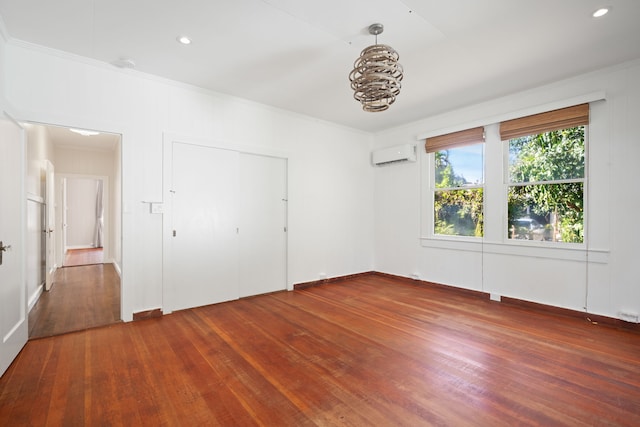3018 Poipu Rd, Koloa, HI 96756 - unfurnished bedroom with an AC wall unit, ornamental molding, hardwood / wood-style floors, baseboards, and a closet