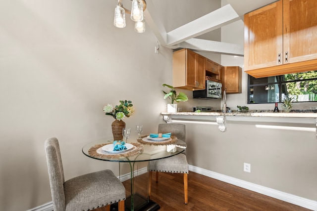 77-301 Noelani Way Unit 36, Kailua-Kona, HI 96740 - kitchen with dark wood-type flooring, baseboards, stainless steel microwave, light countertops, and brown cabinets