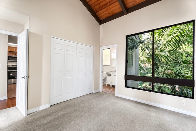 77-301 Noelani Way Unit 36, Kailua-Kona, HI 96740 - unfurnished bedroom with carpet flooring, wood ceiling with exposed beams, baseboards, high vaulted ceiling, and a closet